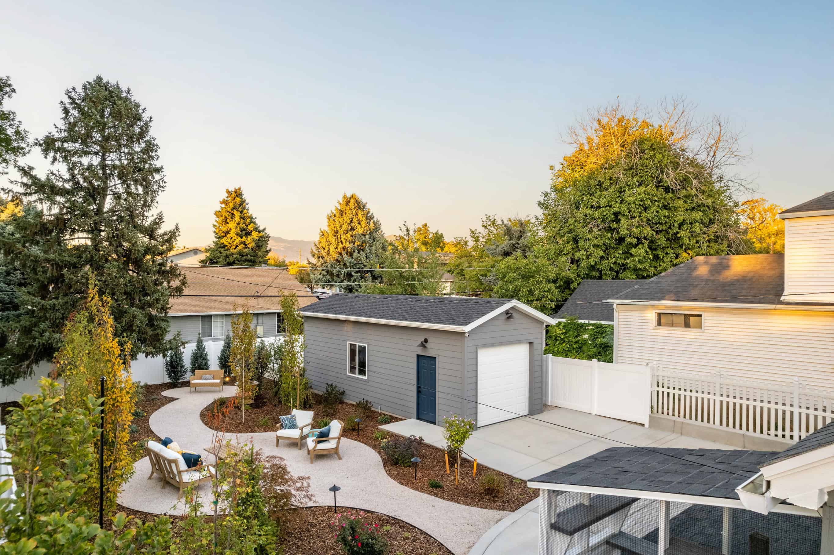 Custom garage with a sustainable xeriscape design featuring native plants, gravel pathways, and eco-friendly landscaping elements.