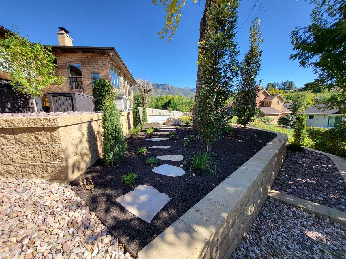 Retaining wall installation in a custom landscape design in Sandy, Salt Lake City.
